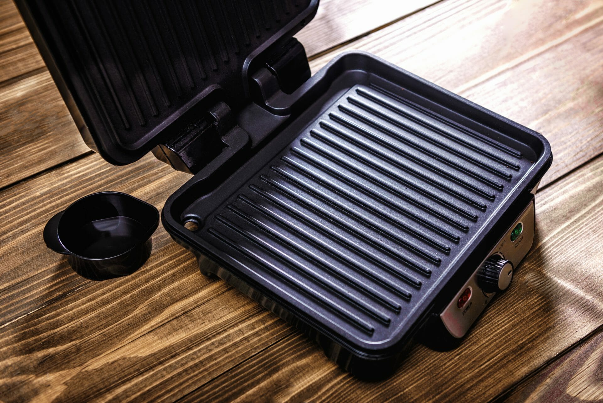 clean electric grill on a wooden surface