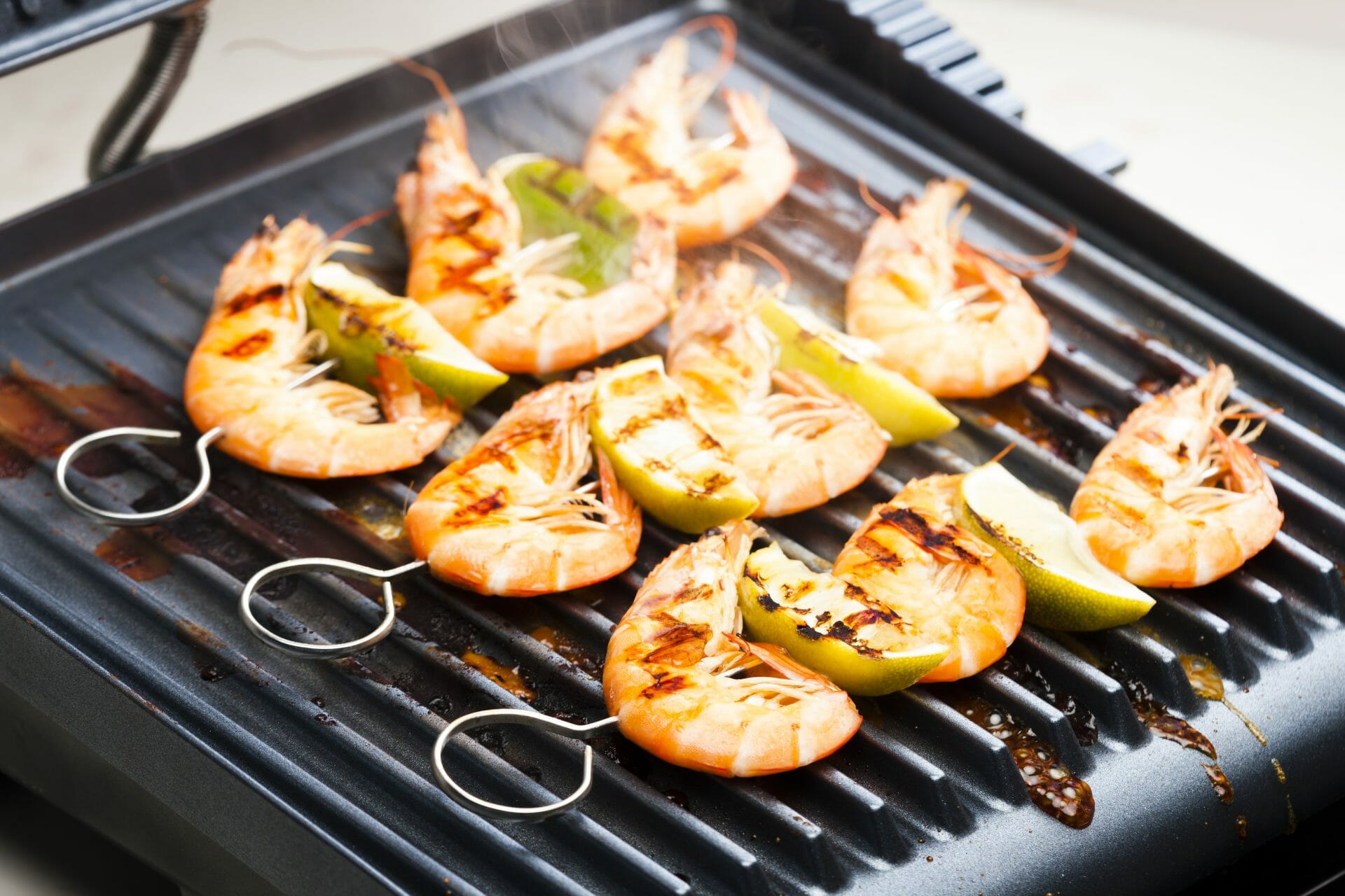 electric grill with shrimps on skews