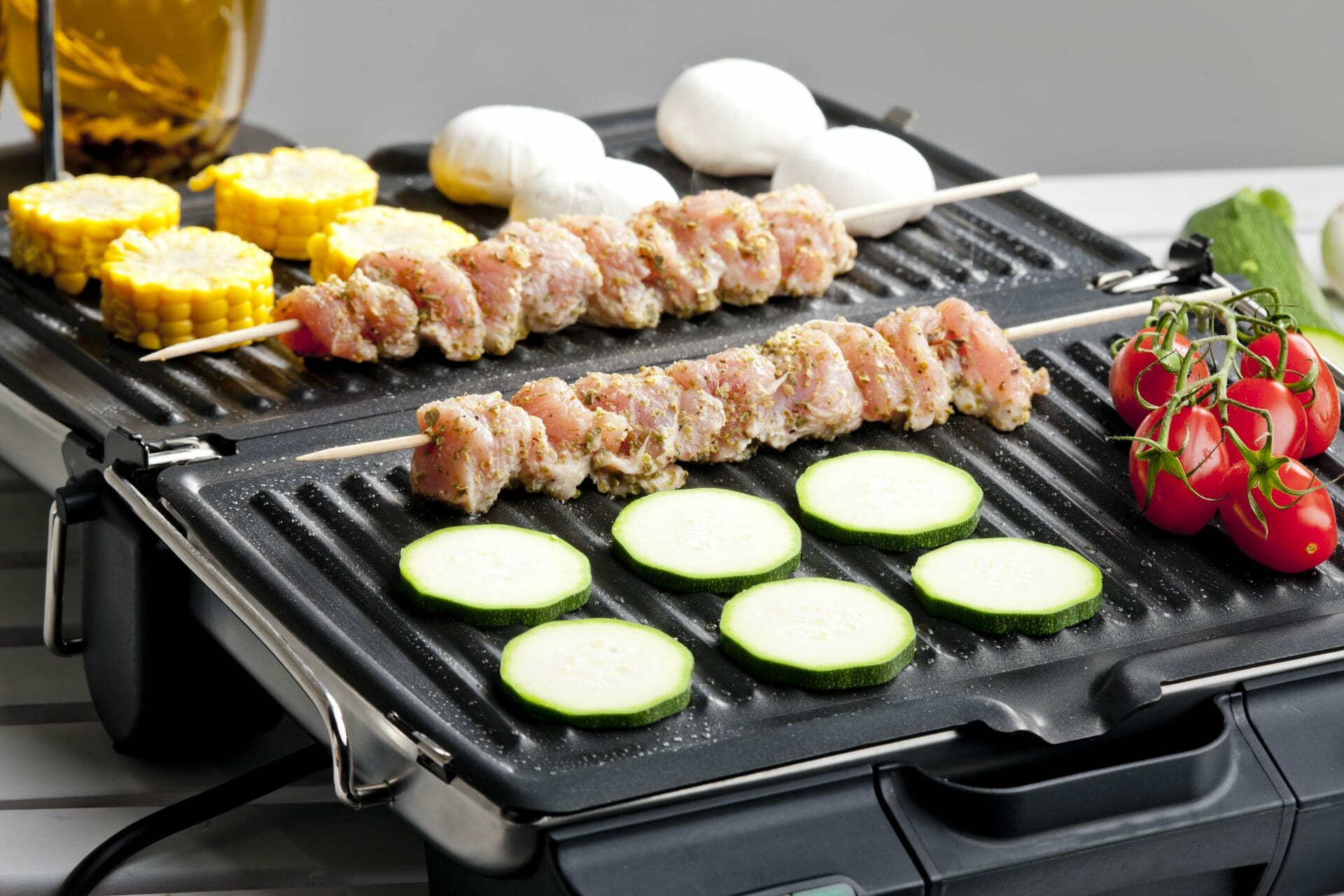 electric grill with meat  on skews an vegetables 