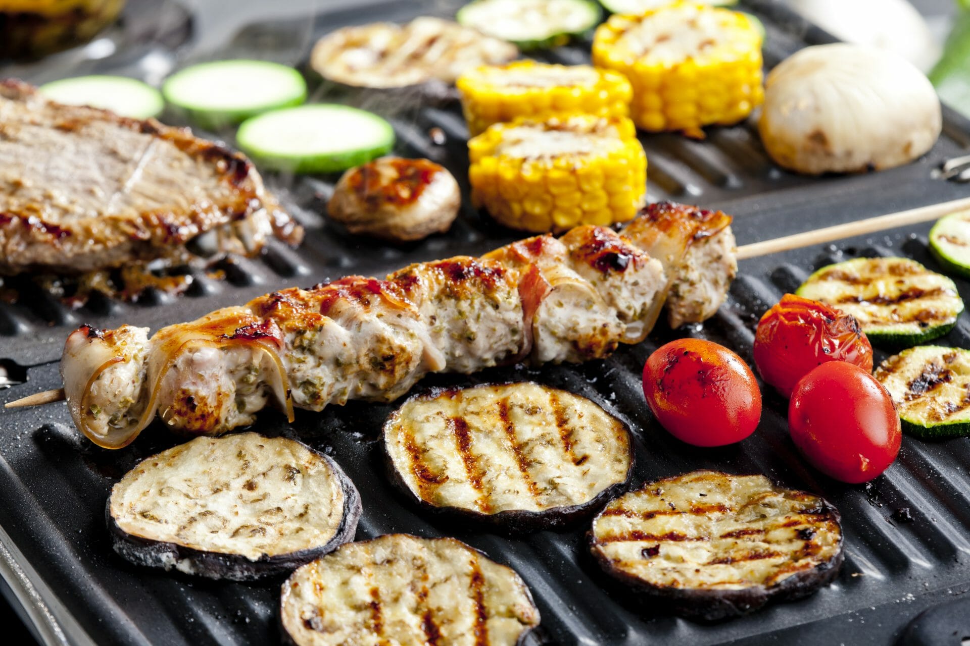 electric grill with meat and vegetables 