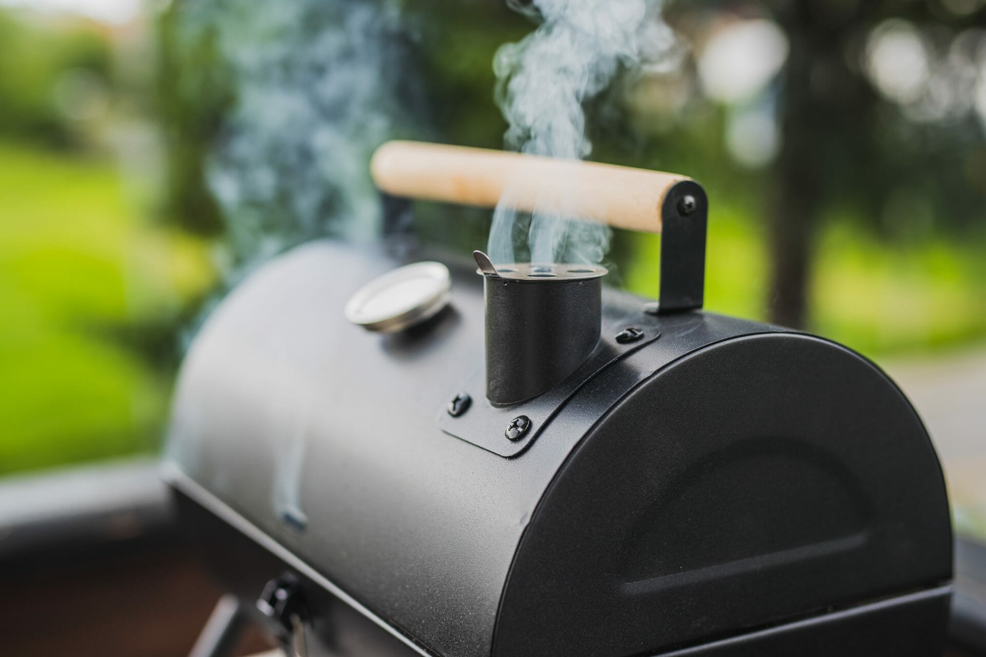 pellet smoker with smoke comes out of it